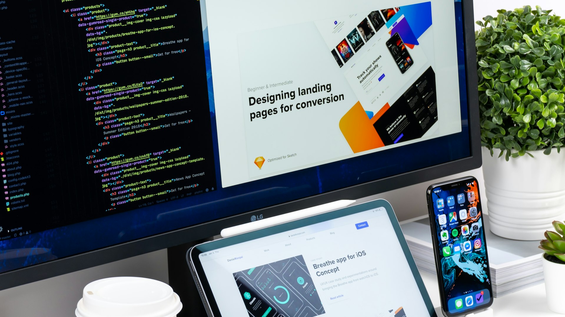 Web designer workspace with code and responsive website layouts representing web design and hosting services